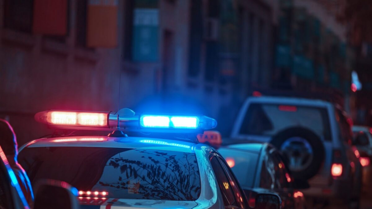photo of a police car with its lights on at night
