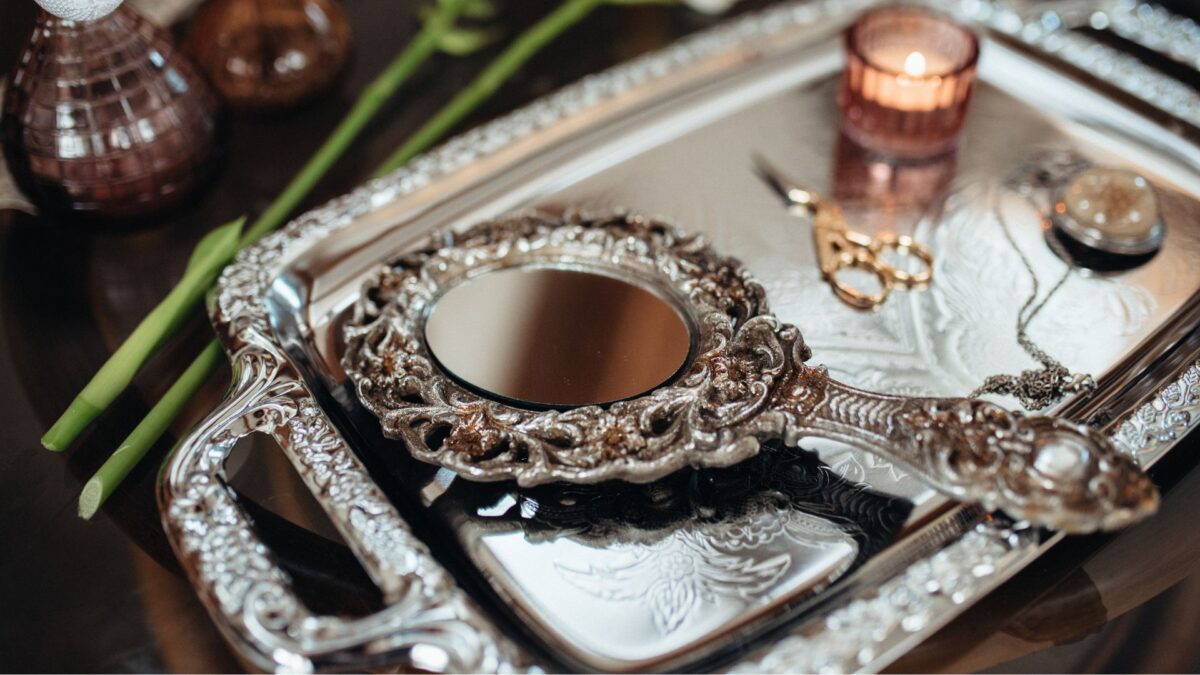 photo of a handheld mirror lying on a tray