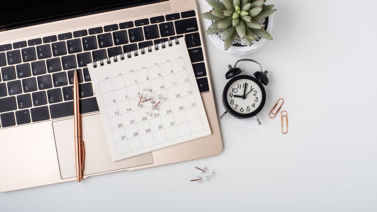 photo of a calendar sitting on a laptop