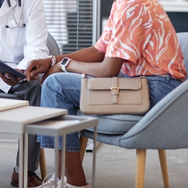 a patient consulting with a podiatrist about her care plan
