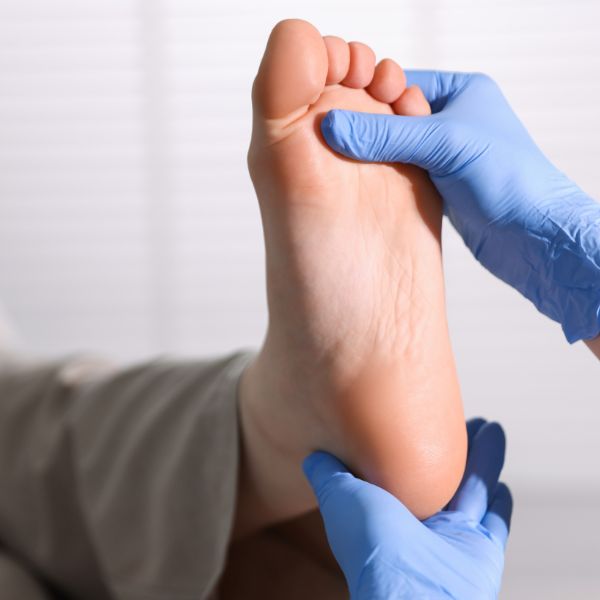 a podiatrist evaluating a foot for minimally invasive surgery in Fort Mill SC