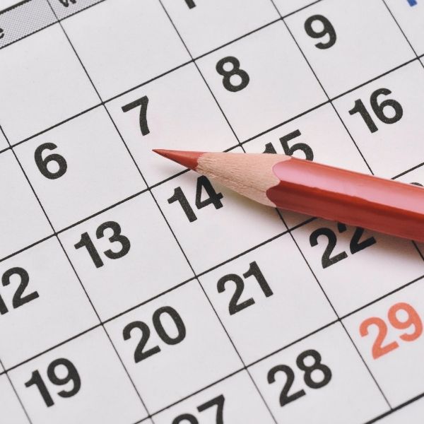 photo of a calendar with a red pencil photo of a calendar with a red pencil