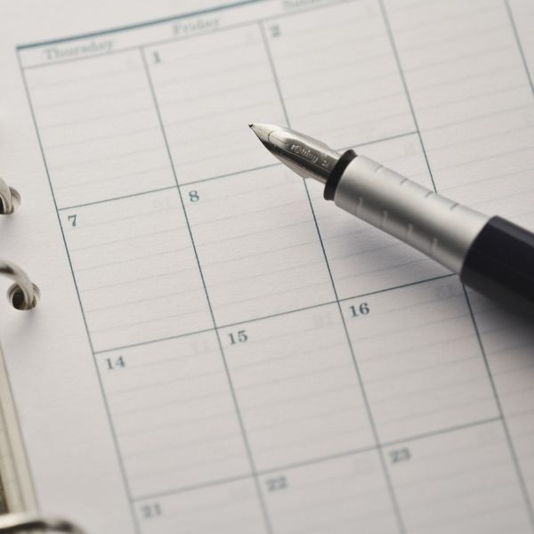 photo of a pen laying on top of a calendar