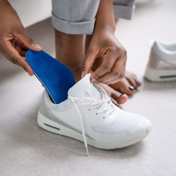 photo of a person placing a custom orthotic into a shoe in Fort Mill SC