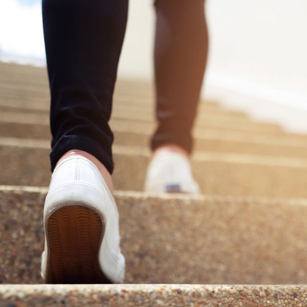 photo of a persona walking up stairs in Fort Mill SC after receiving podiatric rehab