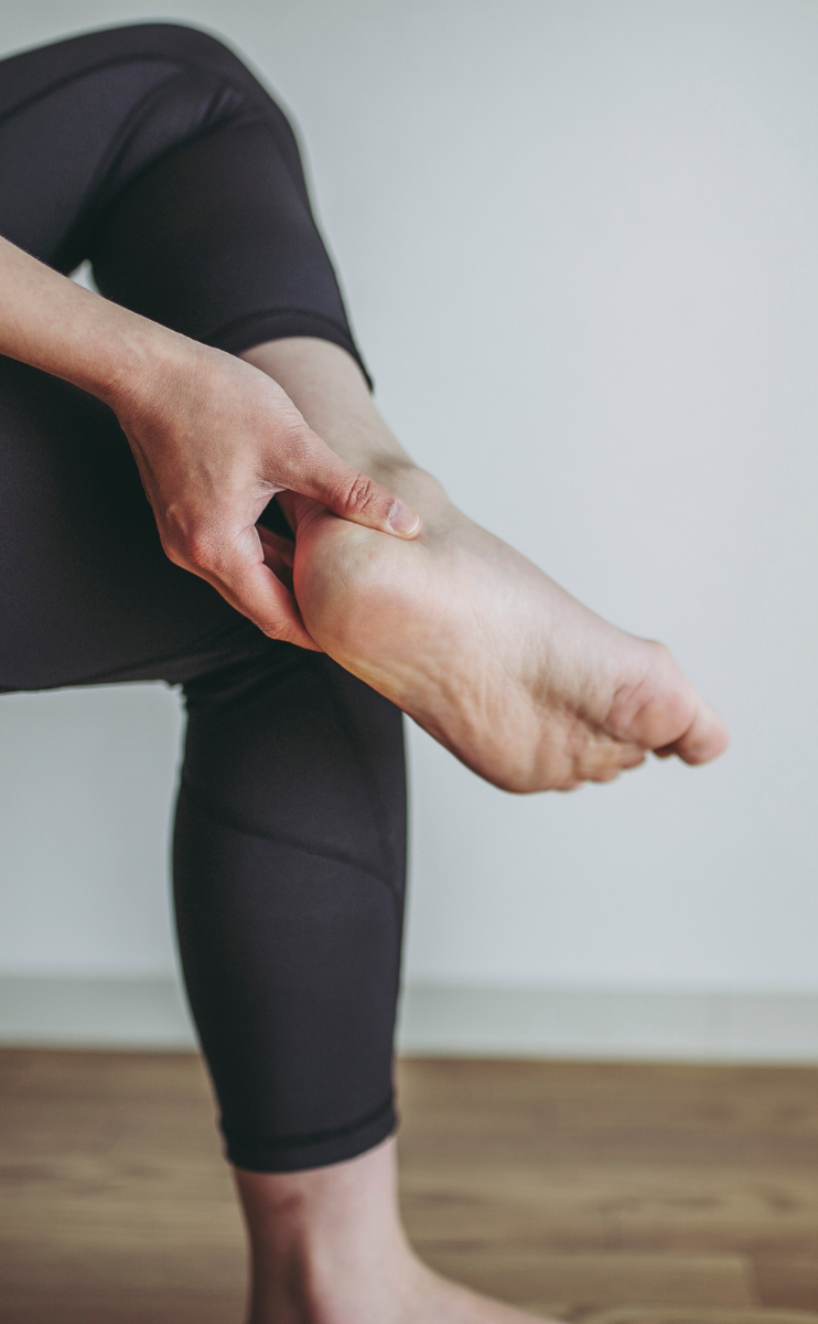 photo of a woman in Fort Mill holding her heel in pain due to plantar fasciitis