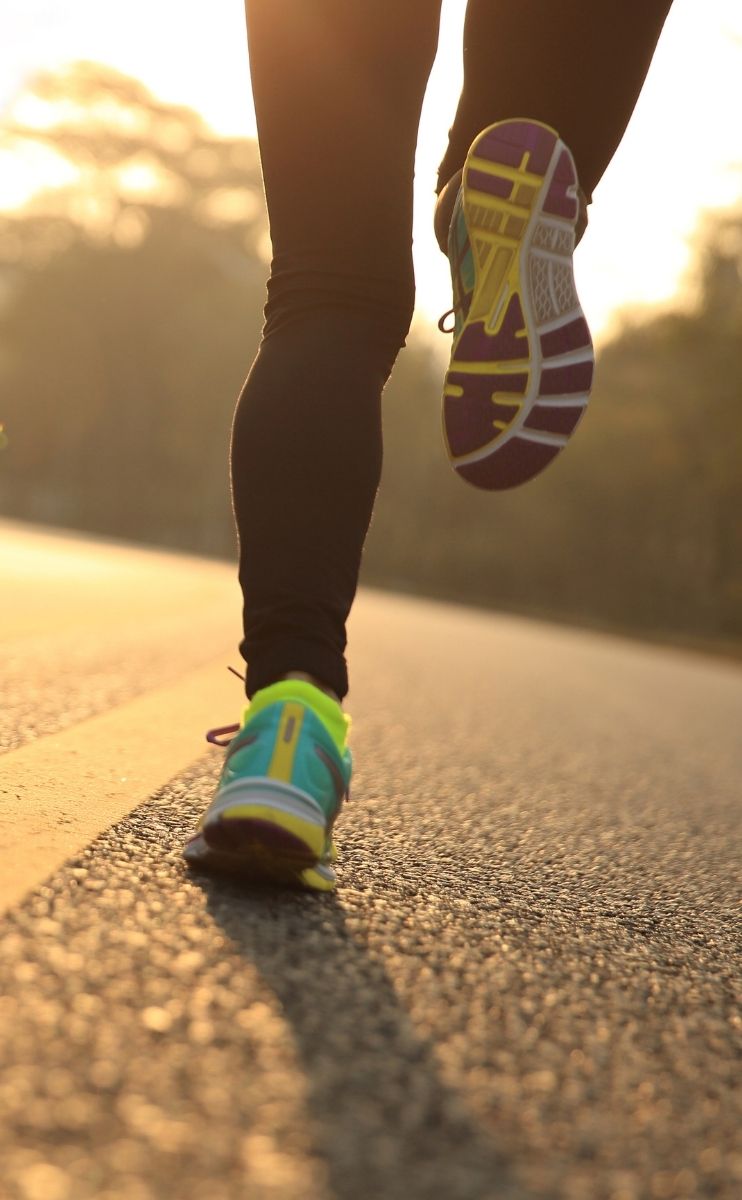 photo of a woman running on a road in Fort Mill at sunset after receiving treatment for bone spurs photo of a woman running on a road in Fort Mill at sunset after receiving treatment for bone spurs