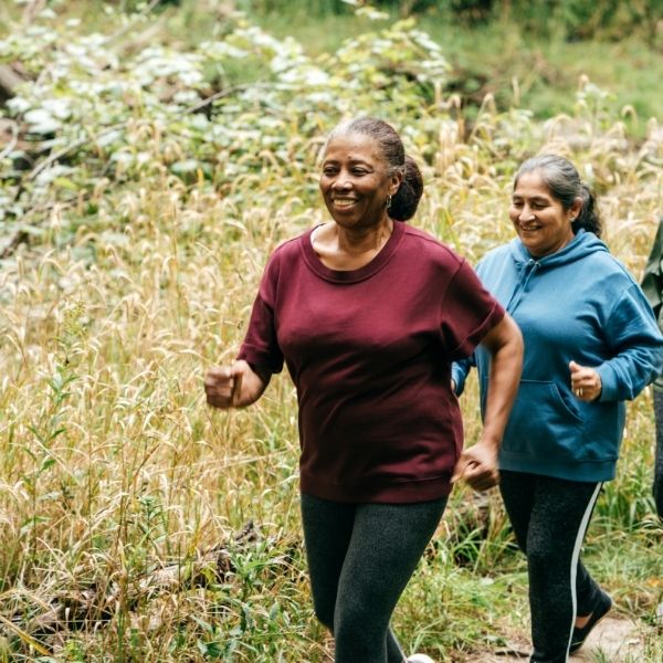 smiling woman walking after having bone spur treatment smiling woman walking after having bone spur treatment