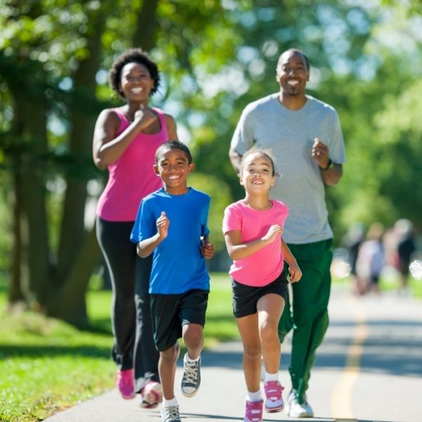photo of a happy family running through a park in Fort Mill SC photo of a happy family running through a park in Fort Mill SC