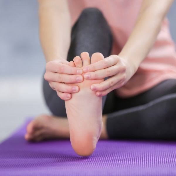 photo of a woman stretching her foot photo of a woman stretching her foot